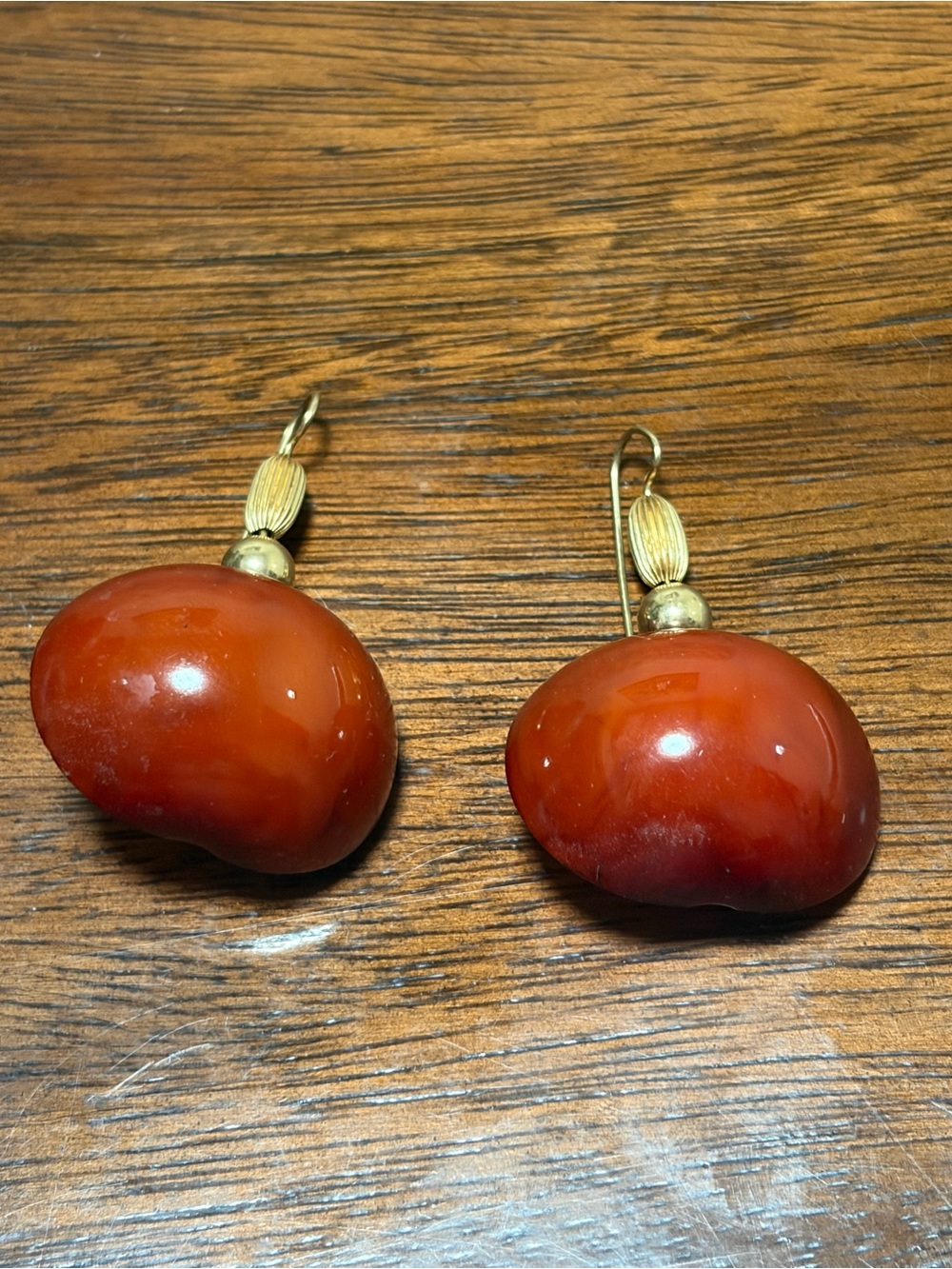 carnelian dangle earrings feature polished orange stones suspended